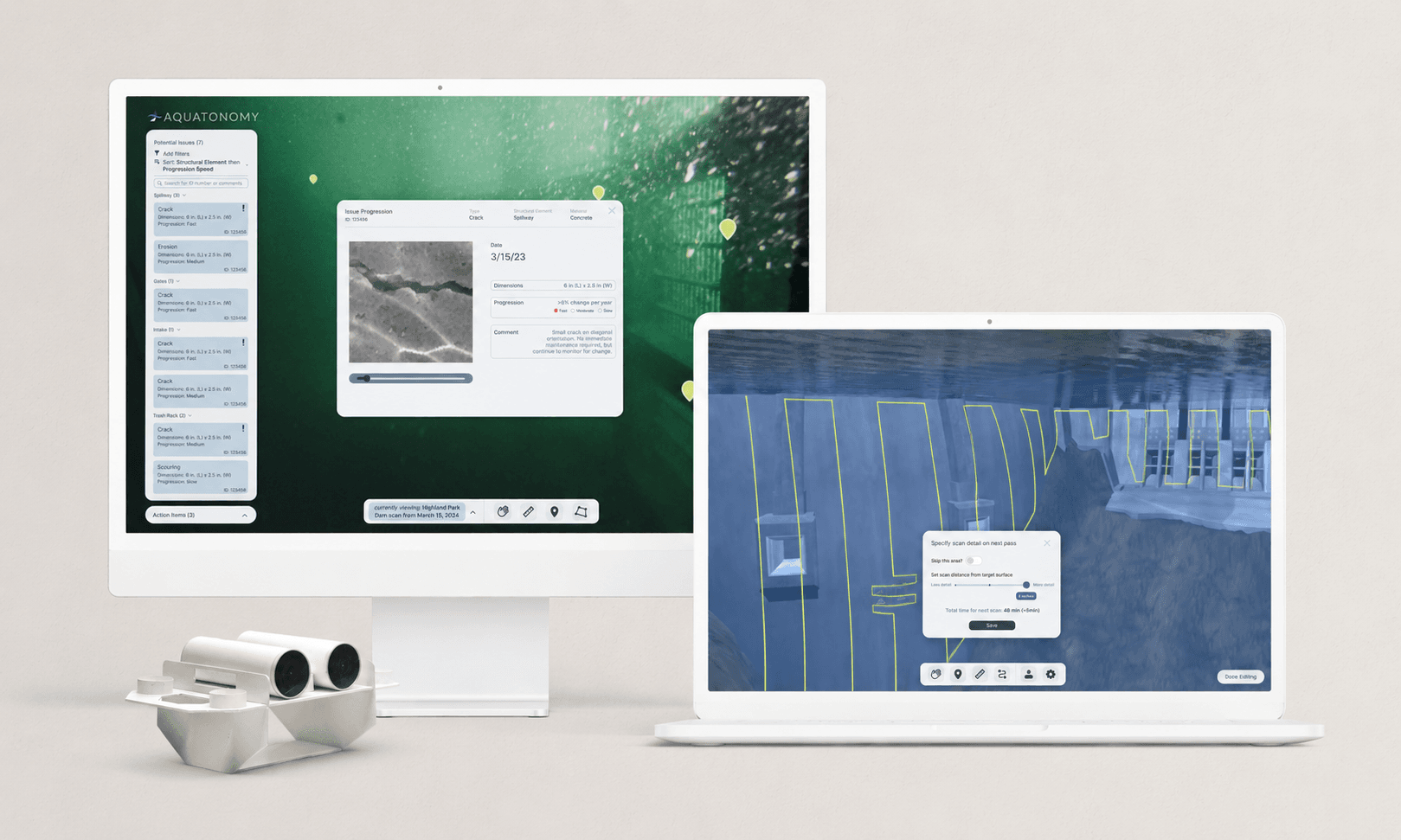 Aquatonomy dam-inspection interface on a desktop and laptop beside an underwater scanning device